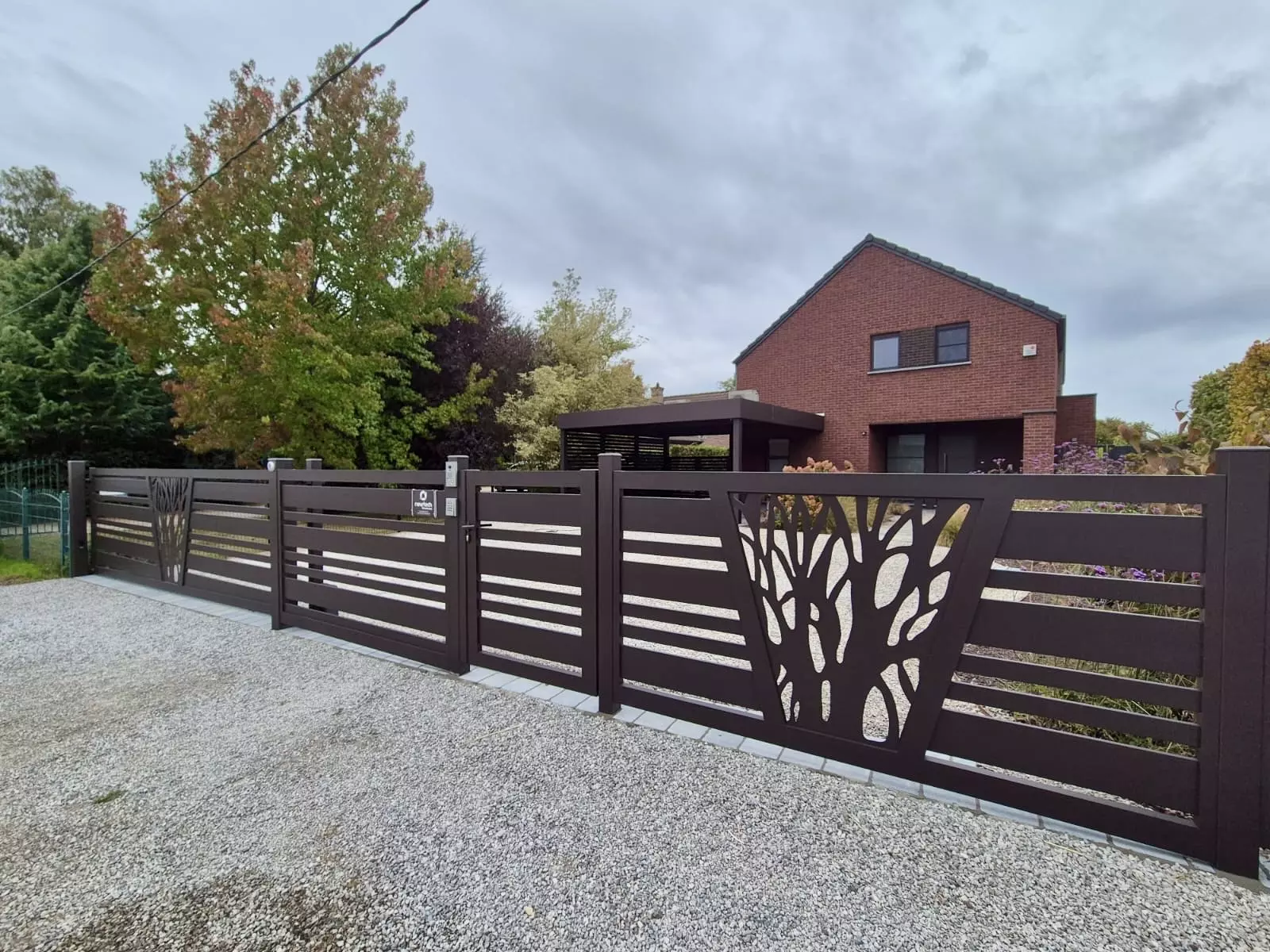 Vue d’ensemble du projet à Autreppe : carport Orion semi-adossé avec bandeau Horizon, portail aluminium coulissant sur pente modèle Saumur décor laser et clôture assortie – conception sur mesure Eurofactory Belgique